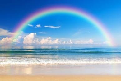 Beautiful sea with a rainbow in the sky. Karon beach, Phuket, Thailand. Asia